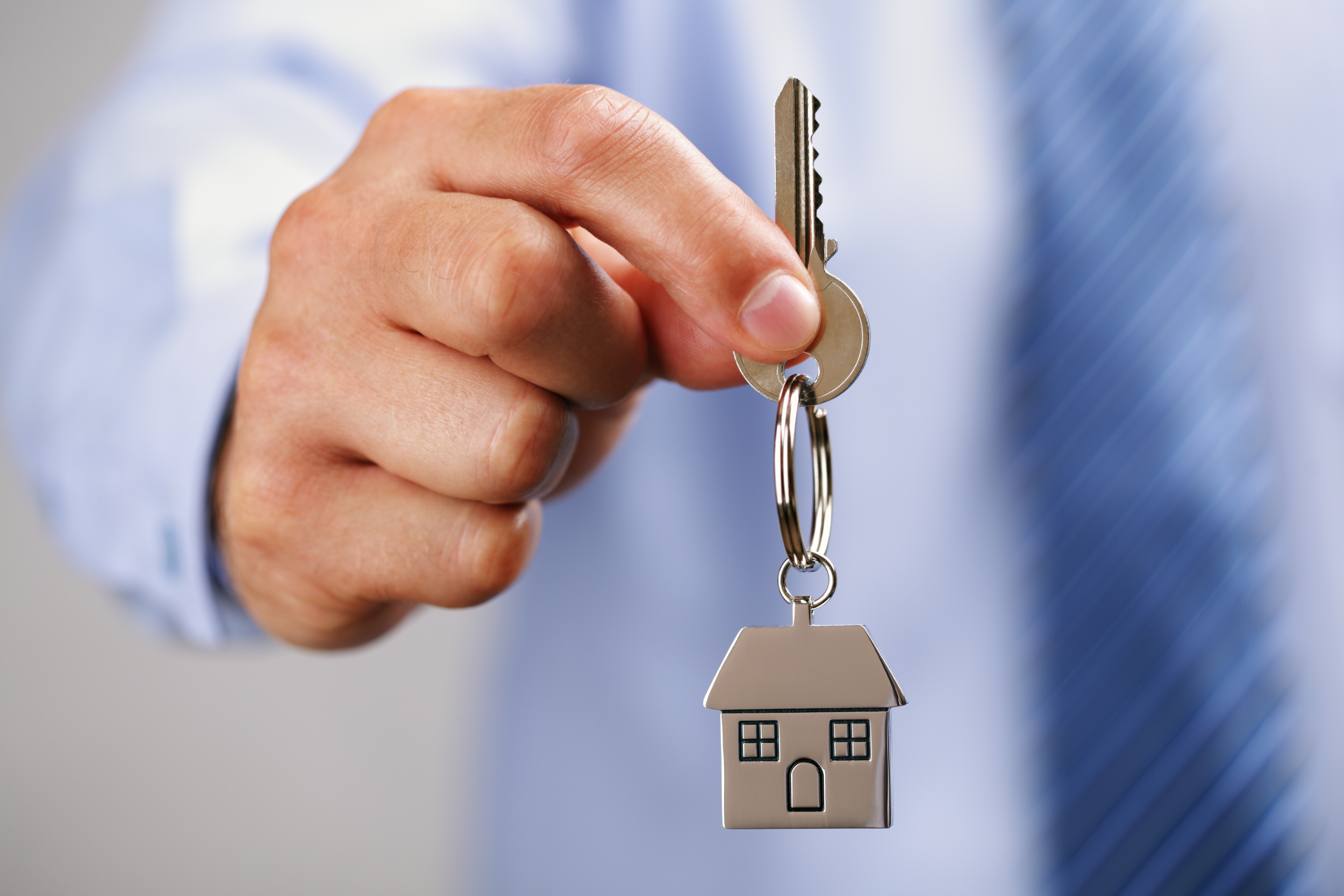 A realtor holding house keys A realtor holding house keys
