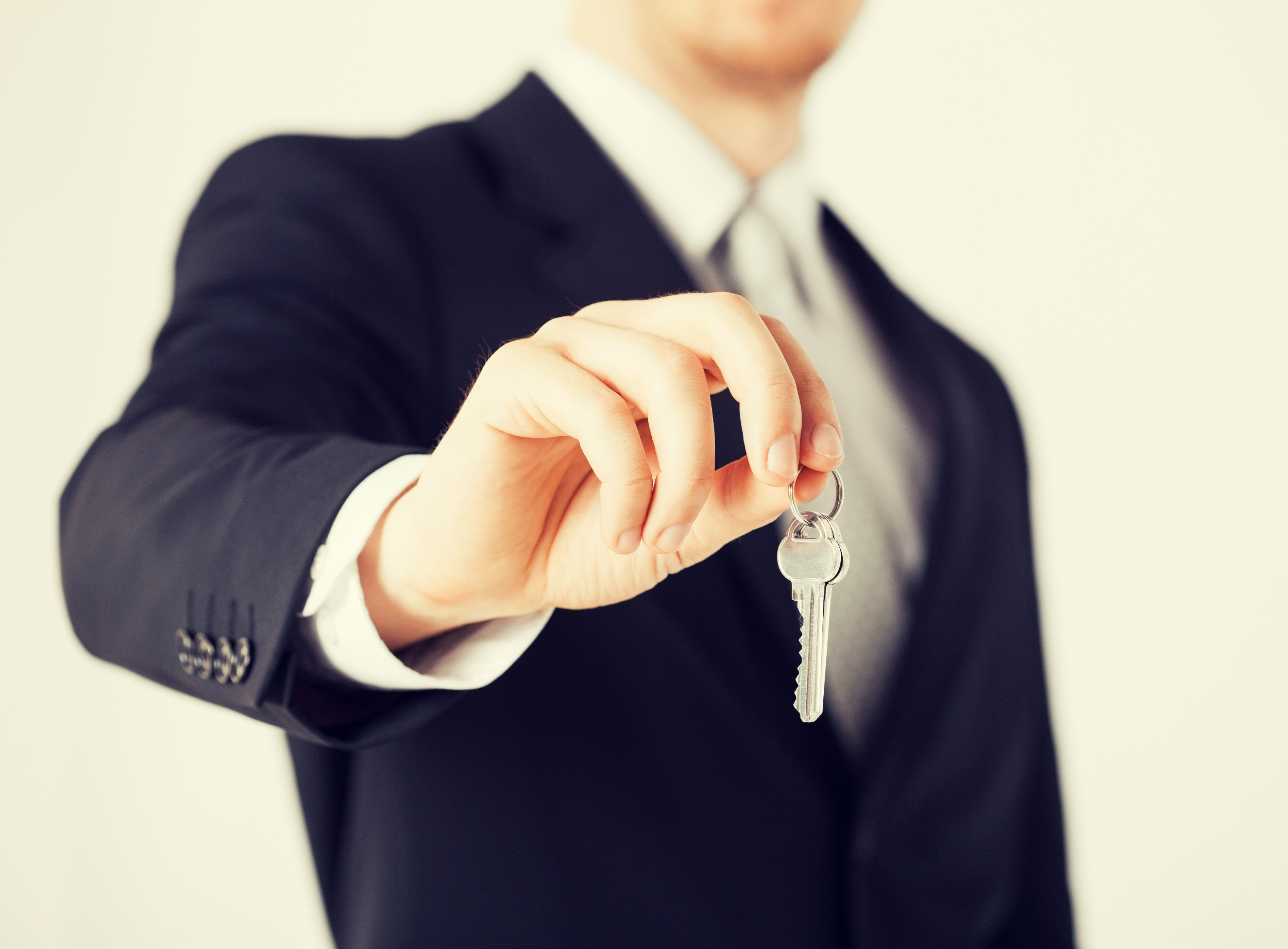 A realtor holding house keys A realtor holding house keys